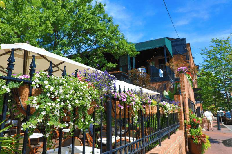 commercial patio, tables, chairs, umbrellas, and flowers