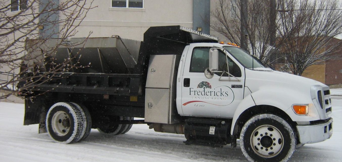 Landscaping company truck preparing for snow removal services