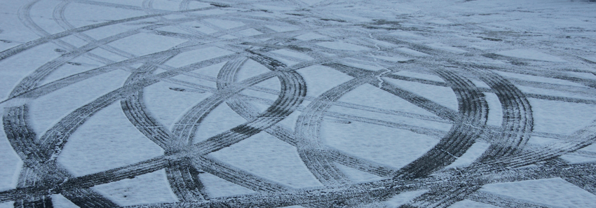 tire tracks in snow-covered pavement