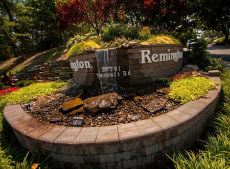 a water feature is one commercial landscaping idea that will draw attention to business signs